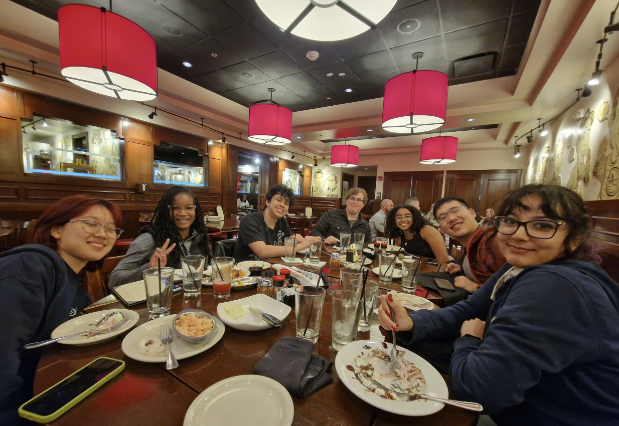 PacBot team members gathered for a meal after competition