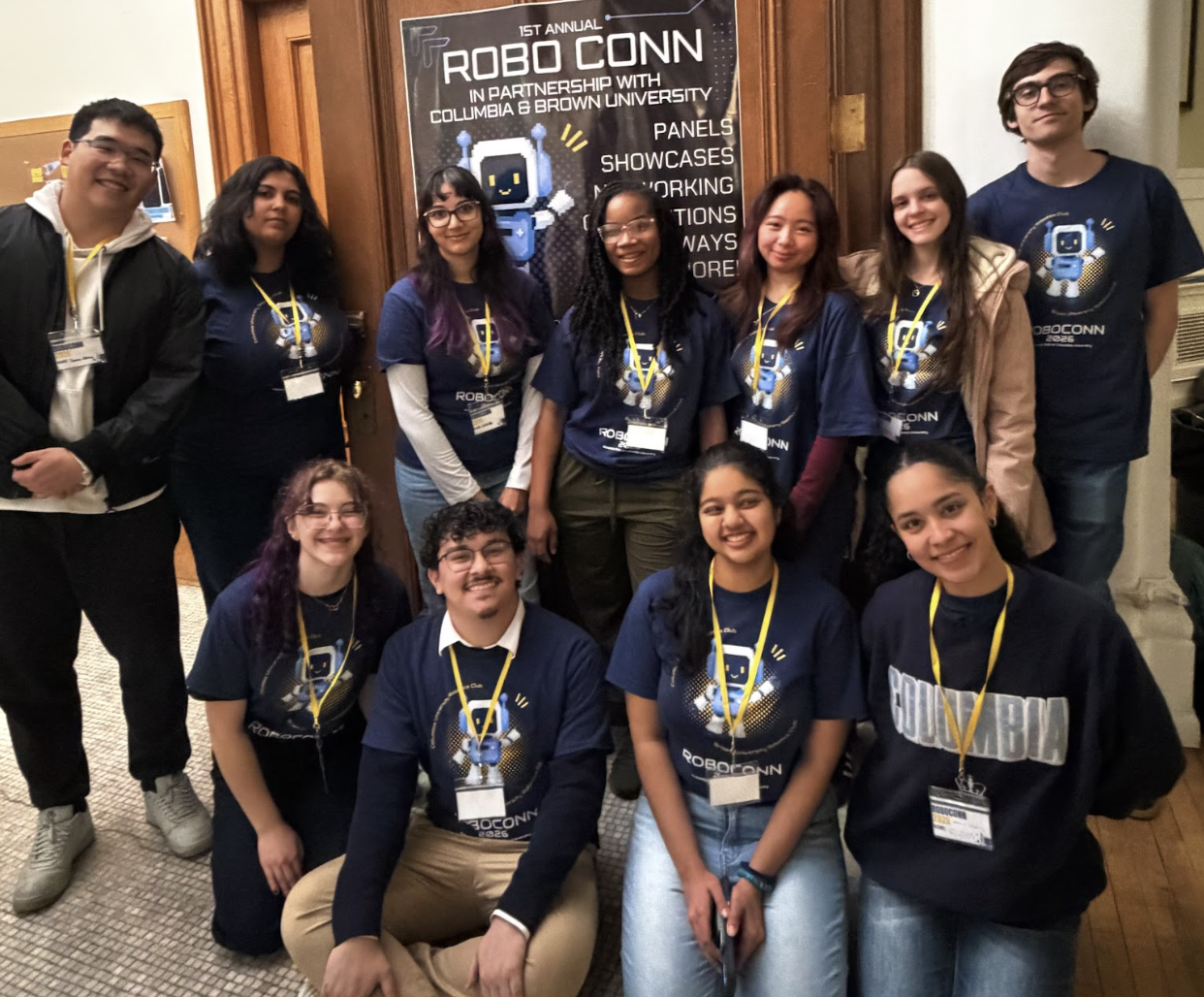 RoboCONN organizers and volunteers posing together in front of the RoboCONN banner